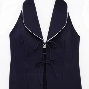Slim fit dark blue halter top with white lace trim, contrast lapel and front bow ties