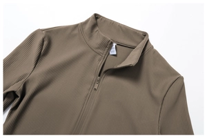Detail of ribbed yoga jacket featuring half-zip stand collar and material wash label