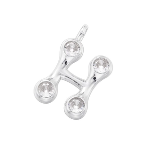 Macro shot of silver letter H pendant featuring four round inlaid sparkling crystals