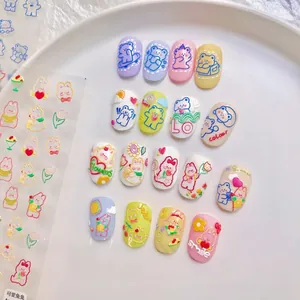 Detail of 3D embossed nail art stickers with colorful cartoon bears and floral texture