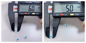 Calper measurement showing detailed 6.0mm and 5.0mm blue mop evil eye shell beads