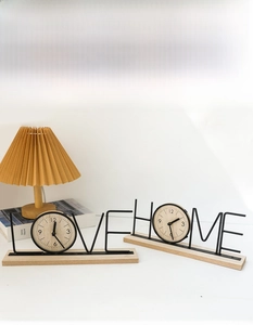 Detail of Nordic LOVE and HOME metal desk clocks with wooden bases and dial accents