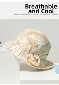 Détail d'un chapeau de paille pour femme avec un grand nœud en soie et des perles élégantes