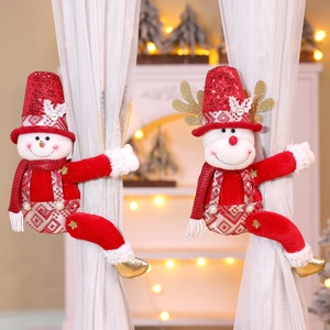 Detail of Christmas snowman and reindeer curtain buckles with red sequins and glitter