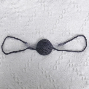 Detail of grey handmade crochet mask prop for Halloween and cosplay party accessories