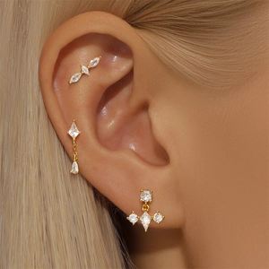 Close-up of three gold S925 silver stud earrings with marquise and drop-shaped opals