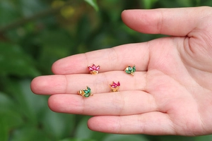 Chic gold stud earrings with colorful marquise-cut gems in a dainty leaf-cluster design