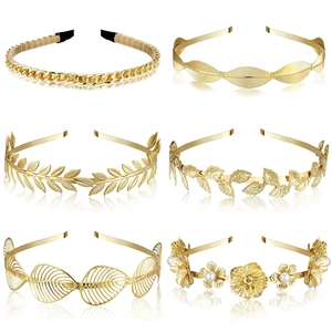 Detail view of six golden bridal headbands with pearls and floral leaf designs