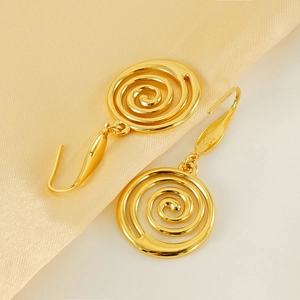 Vintage gold plated stainless steel spiral earrings on champagne satin background