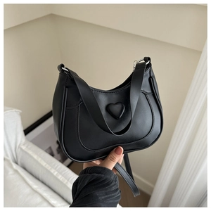 Chic black saddle bag for women with a 3D heart-shaped decor and detachable shoulder strap