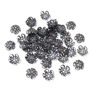Detailed close-up of hollow gunmetal iron flower bead caps for DIY jewelry making