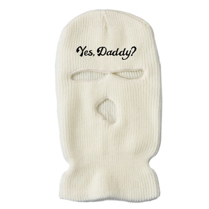 Close-up of white ribbed knit ski mask with Yes Daddy text embroidery on forehead