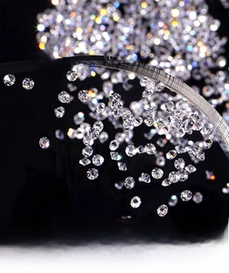 Macro detail of iridescent wizard micro diamonds for nail art on a dark background