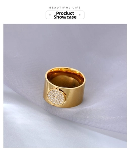 Macro shot of wide gold ring featuring micro-paved cubic zirconia on silk background
