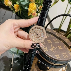 Luxury rose gold women's watch with diamond bezel and black leather strap in lifestyle setting