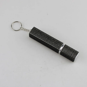 Macro detail of black rhinestone-studded perfume spray bottle with keychain hook