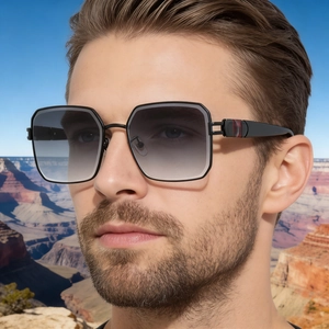 Close-up of stylish black square sunglasses with metallic details on a male model