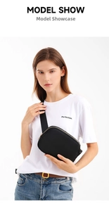 Model wearing a minimalist black large capacity sports waist bag with golden zipper