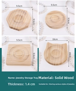 Detail showing various wooden jewelry display trays in round, square, and cat shapes