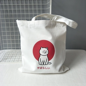 Close-up of white canvas tote bag with Japanese text 'Subarashii' on white desk