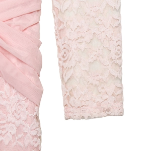 Detailed view of pink mesh ruched fabric with intricate floral lace sleeve stitching