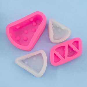 Detailed close-up of pink and translucent silicone molds for watermelon-shaped desserts