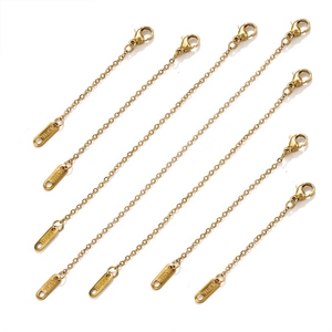 Macro view of gold-plated stainless steel extension chains with S.STEEL engraved tags