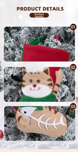 Detail of Christmas cat stocking showing hanging loop, plush face, and fish bone design