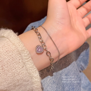 Detail of double-layer silver bracelet featuring purple heart zircon and elegant O-chain