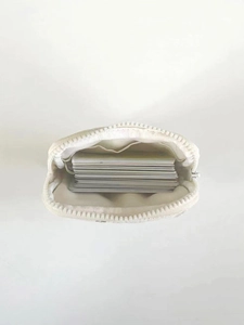 Internal view of a white quilted card holder showing capacity for multiple cards