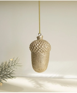 Detail of champagne gold glitter acorn ornament with pine needle decor for Christmas trees
