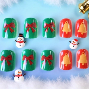 Christmas press-on nails set with red bows and golden bells on green and red base