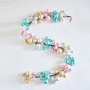 S-shaped Christmas ornament branch with pearlized gold, silver and blue spheres decoration