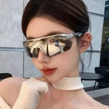 Close-up of silver futuristic sports sunglasses with gold mirrored lenses and wrap frame