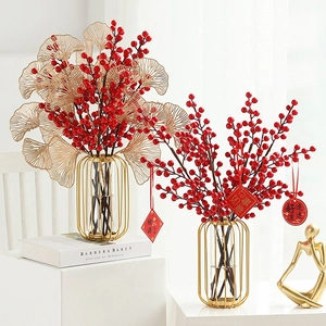 Detail of red berries and golden ginkgo leaves in a festive Chinese New Year vase