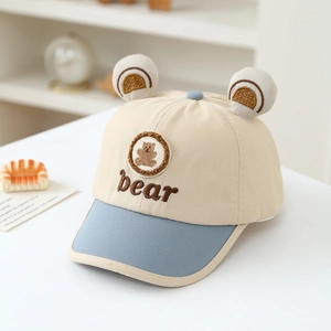 Close-up of baby baseball cap with 3D bear ears and embroidered bear patch detail