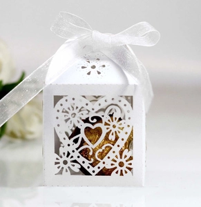 Detailed laser-cut heart candy box in white with a delicate organza ribbon bow