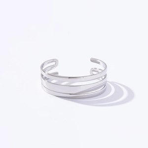 Close-up of minimalist silver triple-layered open cuff bracelet in stainless steel