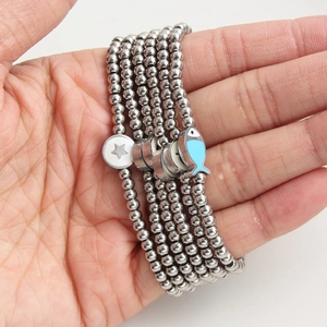 Five-strand stainless steel beaded bracelet featuring blue fish and star pendants