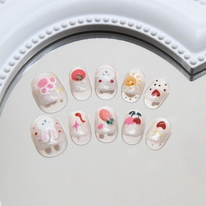 Cute pink glitter cat eye press-on nails with cartoon rabbit and carrot designs
