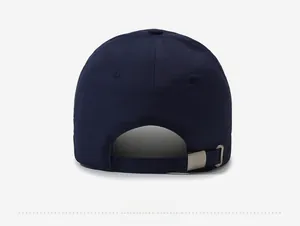 Detail of navy baseball cap back featuring silver metal buckle and adjustable strap