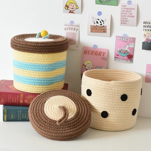 Detail of handmade cotton rope storage baskets with lids and colorful woven patterns