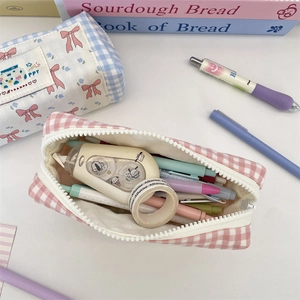 Detail view of plaid pencil cases showing spacious capacity for various stationery items