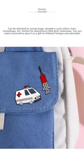 Detail of medical enamel pins with ambulance and syringe on a blue canvas bag fabric