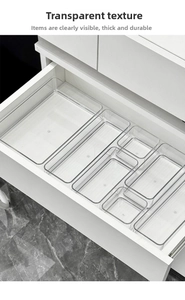 Close-up of clear acrylic drawer organizer trays for stationery and cosmetics storage