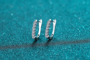 Macro shot of high-quality silver hoop earrings with shimmering clear moissanite stones