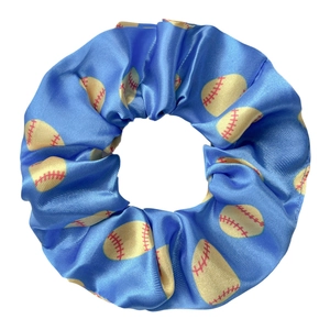 Détail du chouchou en satin bleu avec motif de baseball jaune et texture plissée