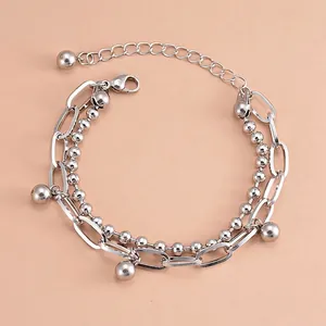 Close-up of double-layer stainless steel bracelet with ball charms and adjustable clasp