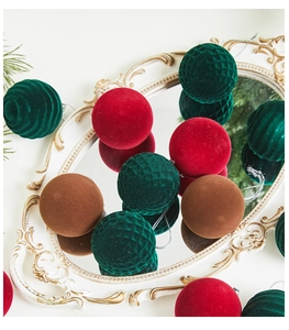 Detail of flocking Christmas balls in red green and brown on a vintage mirror tray