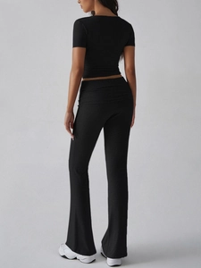 Rear view of black Y2K crop top and flared pants set highlighting slim fit tailoring